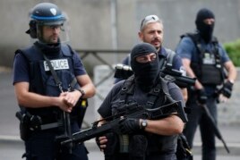 French police and anti-crime brigade (BAC) members secure a street as they carried out a counter-terrorism swoop at different locations in Argenteuil, a suburb north of Paris, France, July 21, 2016.