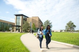 Students walk across campus at Valencia College in Orlando, Florida.