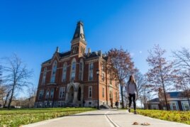 A student walks across the East Campus of DePauw University in Greencastle, Indiana.