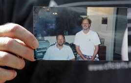 Eric Paddock holds a photo of him, at left, and his brother, Stephen Paddock, at right, outside his home, Monday, Oct. 2, 2017, in Orlando, Fla. Stephen Paddock opened fire on the Route 91 Harvest Festival on Sunday killing dozens and wounding hundreds. (AP)