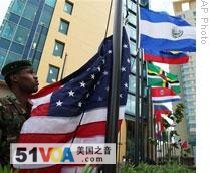 A soldier in Port of Spain raises the U.S. flag in preparation for the Summit of the Americas