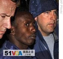Agents bring piracy suspect Abdiwali Abdiqadir Muse to the New York office of the Federal Bureau of Investigation