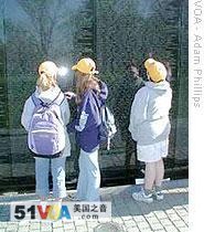 Children examine names of the dead at the Vietnam Veterans Memorial