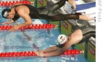 Paul Biedermann, bottom, and Michael Phelps at the start of the 200 meter freestyle