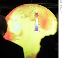 Summit delegates look at a display showing the warming of the world's oceans
