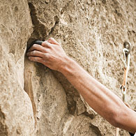 A climber uses a hand hold