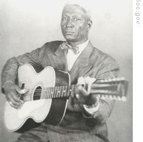 Huddie 'Lead Belly' Ledbetter with his 12-string guitar in a 1940s publicity photo