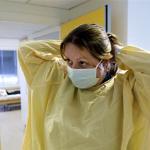 A medical worker prepares to visit patients with an antibiotic-resistant infection at a retirement home in Oslo, Norway