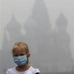 A girl in Moscow wears a mask to protect her from thick smog caused by wildfires last week