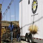  Workers clean outside the Central Coast Agriculture Cooperative's mobile slaughterhose