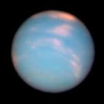 A Hubble Space Telescope picture of Neptune taken to mark the anniversary of the planet's discovery. Neptune is a blue globe with pink clouds seen with computer aided color.